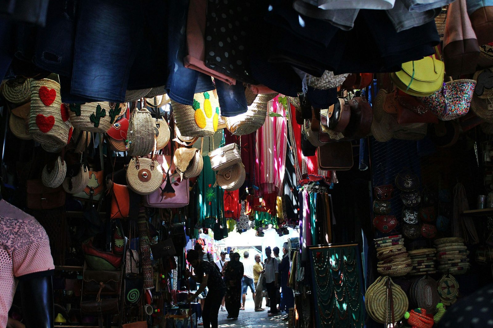 a group of people walking through a market